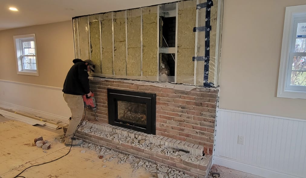 man installing fireplace veneers