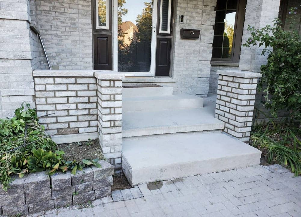 stone porch front with stone wall fence