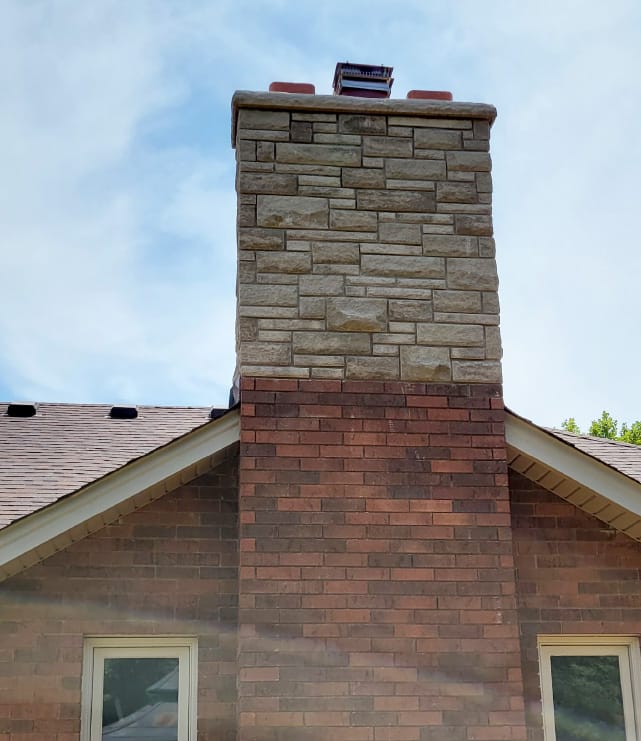 medium size  brick and stone chimney of single family home